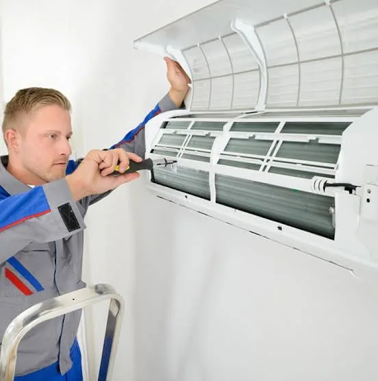 Technician inspecting a residential mini-split unit