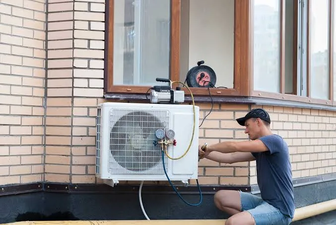 Technician servicing a wall-mounted ductless system
